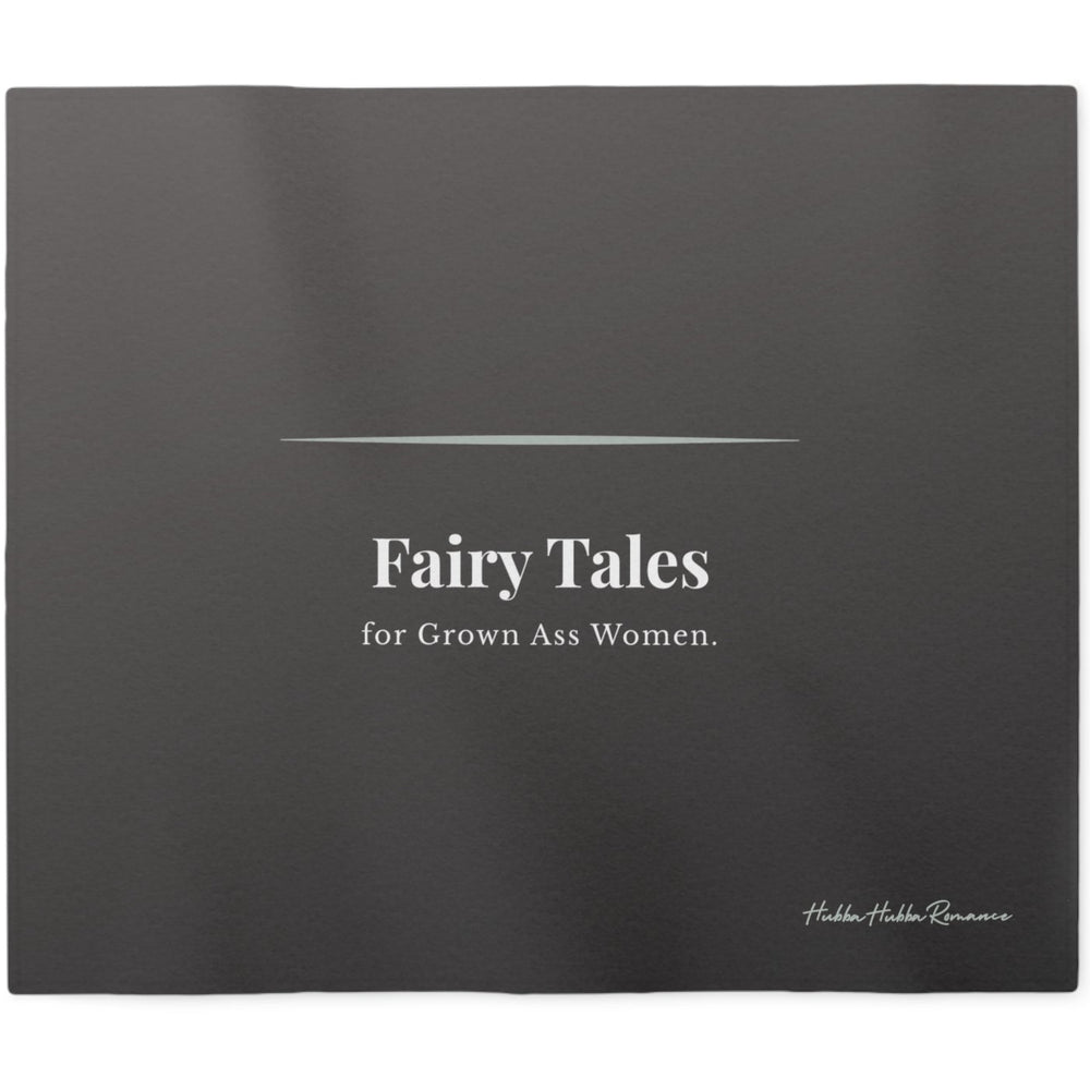 Charcoal gray sweatshirt blanket displaying the phrase "Fairy Tales for Grown Ass Women" in elegant typography. Cozy romance reader blanket celebrating modern fairy tales and happily-ever-afters.