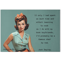 Glass cutting board with a vintage-style image of a woman in a mint green blouse and coral skirt with an orange bow in her hair. The text reads: “If only I had spent as much time and effort on food prep as I do with my book boyfriends, I’d probably be a famous chef by now. Just saying.” Board is rectangular with a textured, tempered glass surface and rubber feet for stability. This is the larger version.