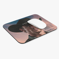 mouse pad displayed with a white compter mouse on it.