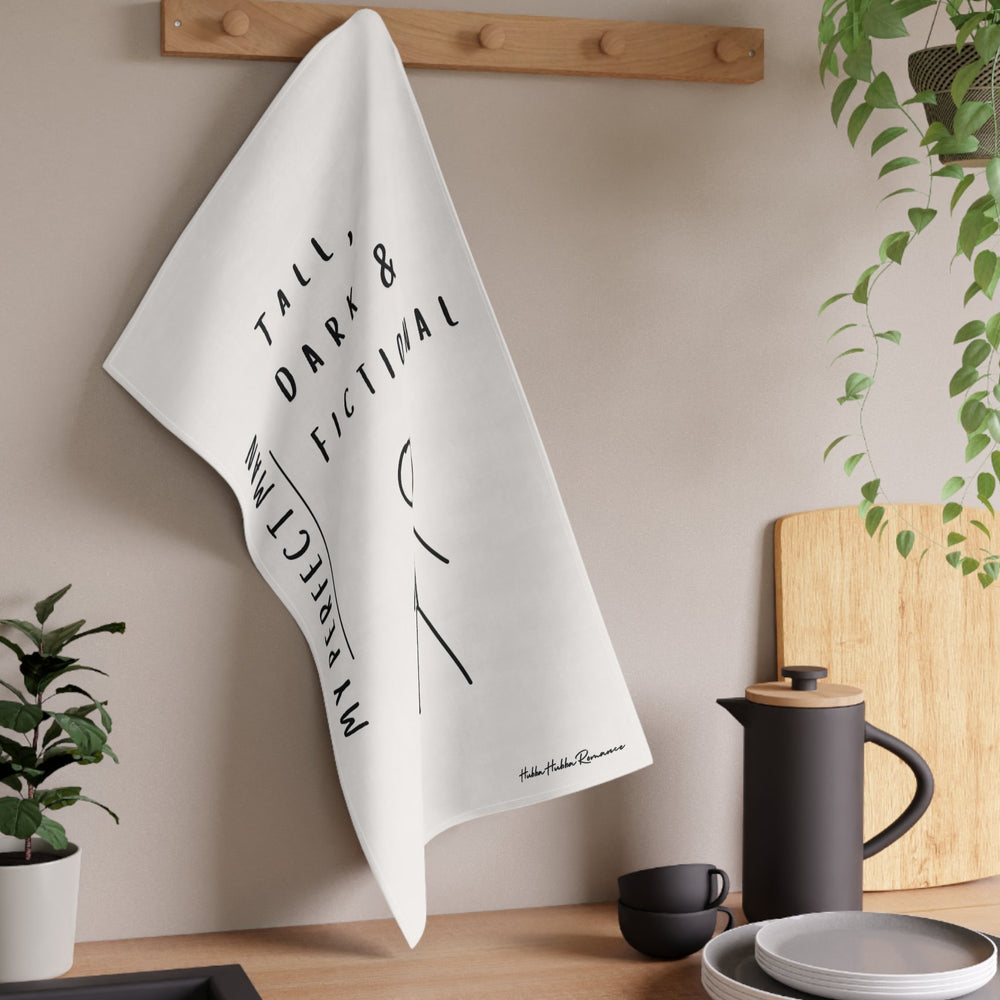 The towel is displayed on a wall hook in a kitchen setting.
