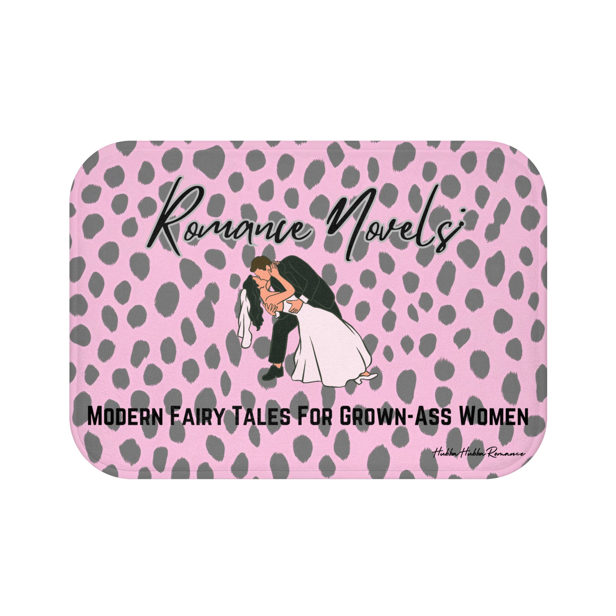 ADA Product Description:
This bath mat features a light pink background with a gray leopard print pattern. Centered near the top is the text “Romance Novels” in a black script font. Below that is an illustrated image of a groom dipping a bride into a dramatic kiss. At the bottom, bold black text reads: “Modern Fairy Tales For Grown-Ass Women.” The mat is soft and absorbent, combining playful design with a bold celebration of the romance genre. This is the smaller version.
