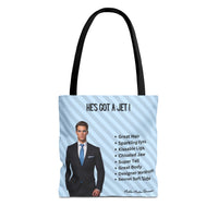This image is an idealized billionaire book boyfriend. He stands confidently against a light blue, diagonal striped background. The text above him reads “He’s Got a Jet.” A checklist beside him includes: Great Hair, Sparkling Eyes, Kissable Lips, Chiseled Jaw, Super Tall, Great Body, Designer Wardrobe, and Secret Soft Side. This is one side of a two-sided tote designed for readers who love the billionaire trope. This is the medium tote.