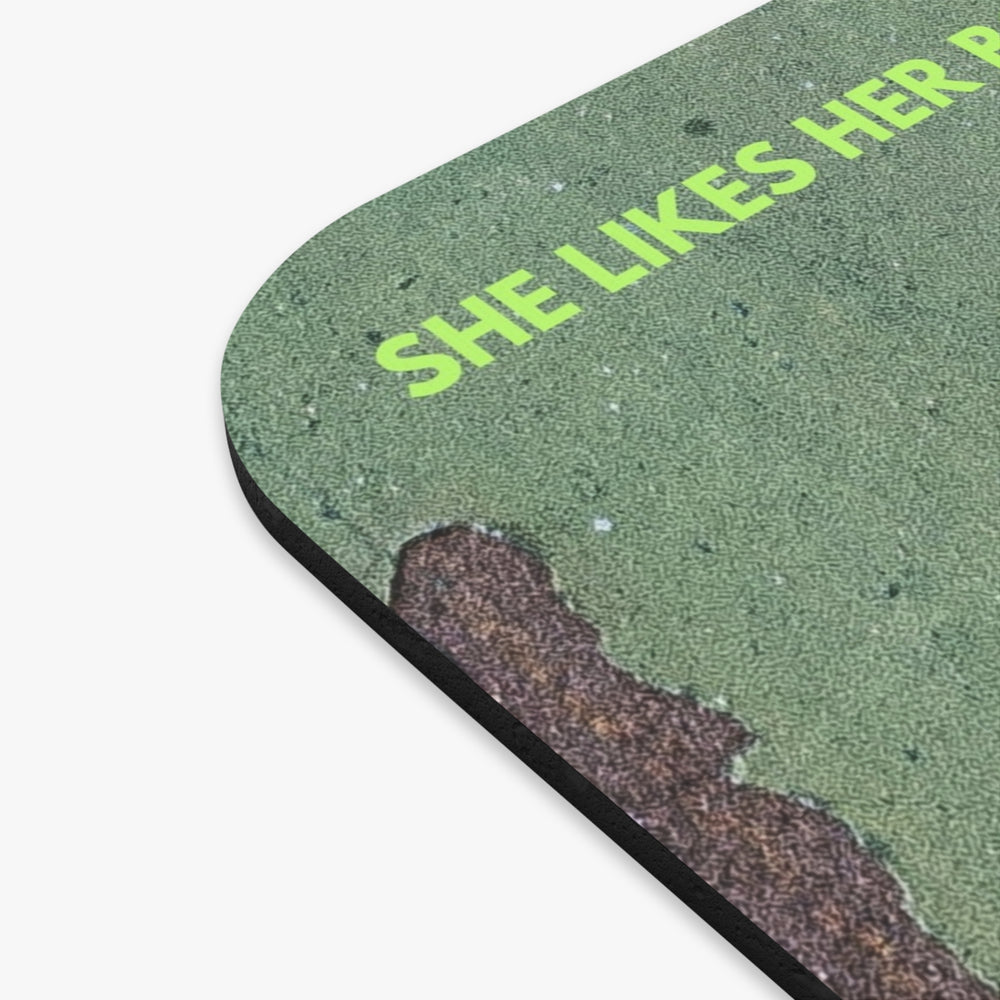 A close-up of the green textured mouse pad with rounded corners, featuring the phrase 'SHE LIKES HERBook Boyfriends Complicated.