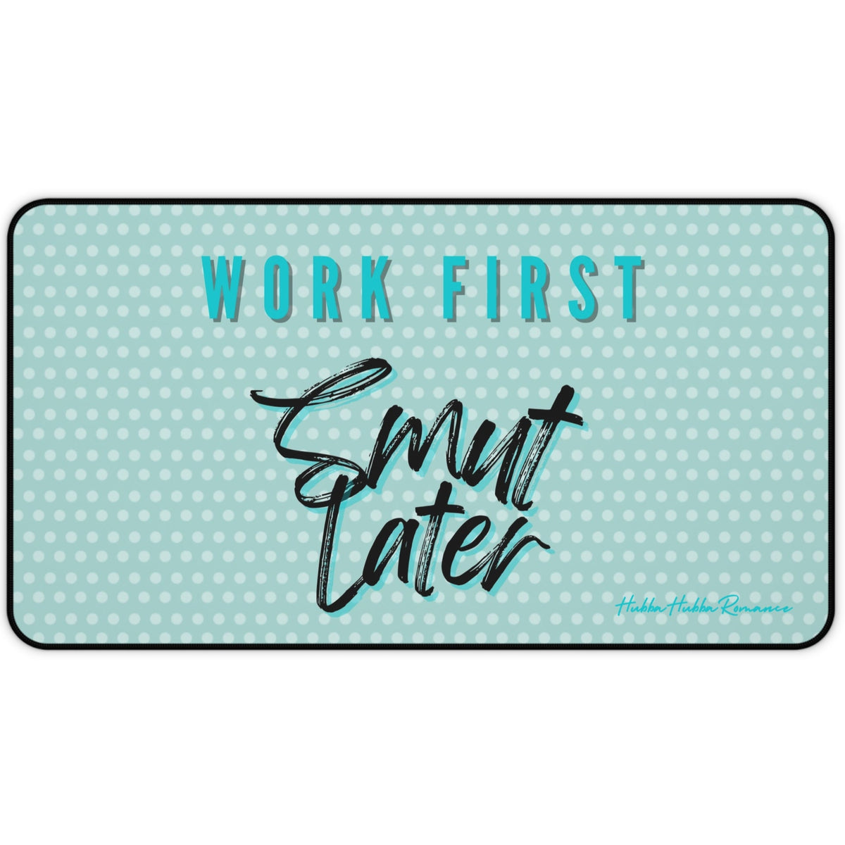 Light green desk mat with a white polka dot pattern. Bold teal block text with a black shadow at the top reads “WORK FIRST,” and large, black brush script text with a teal shadow below says “Smut Later.” The playful design contrasts structured productivity with cheeky reading preferences. This is the medium version.