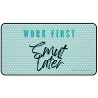 Light green desk mat with a white polka dot pattern. Bold teal block text with a black shadow at the top reads “WORK FIRST,” and large, black brush script text with a teal shadow below says “Smut Later.” The playful design contrasts structured productivity with cheeky reading preferences. This is the medium version.