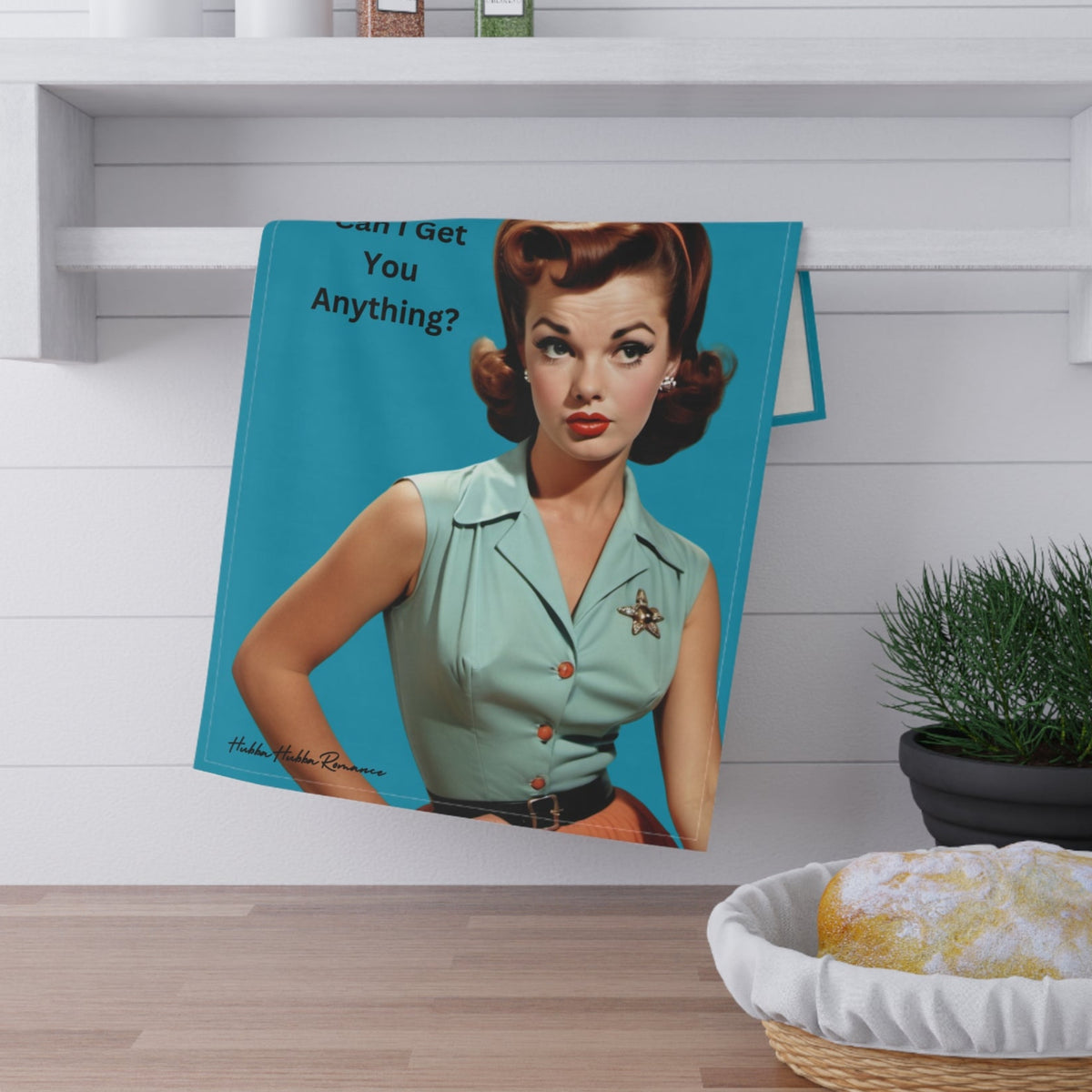 The towel is displayed by folding it over a towel bar underneath a shelf.