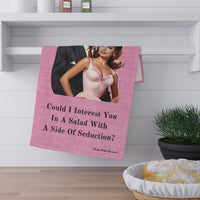 The towel is displayed by folding it over a towel bar underneath a shelf.
