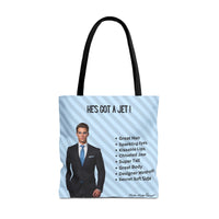 This image is an idealized billionaire book boyfriend. He stands confidently against a light blue, diagonal striped background. The text above him reads “He’s Got a Jet.” A checklist beside him includes: Great Hair, Sparkling Eyes, Kissable Lips, Chiseled Jaw, Super Tall, Great Body, Designer Wardrobe, and Secret Soft Side. This is one side of a two-sided tote designed for readers who love the billionaire trope. This is the small tote. 
