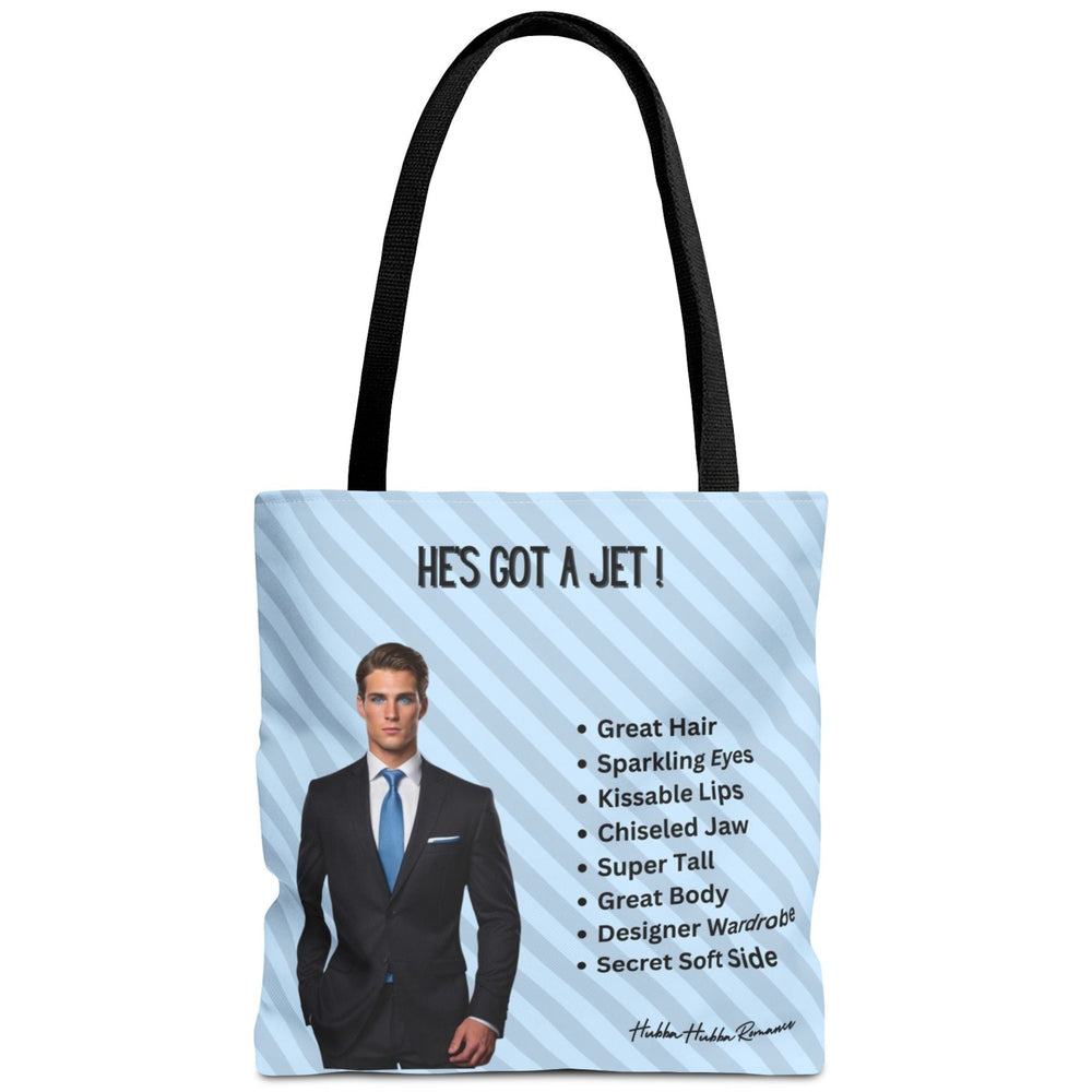 This image is an idealized billionaire book boyfriend. He stands confidently against a light blue, diagonal striped background. The text above him reads “He’s Got a Jet.” A checklist beside him includes: Great Hair, Sparkling Eyes, Kissable Lips, Chiseled Jaw, Super Tall, Great Body, Designer Wardrobe, and Secret Soft Side. This is one side of a two-sided tote.