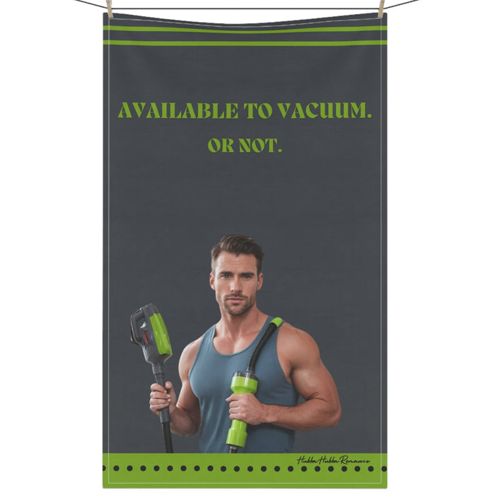 Grey towel with retro man in muscle shirt vacuuming. Text reads: “Available To Vacuum. Or Not.”