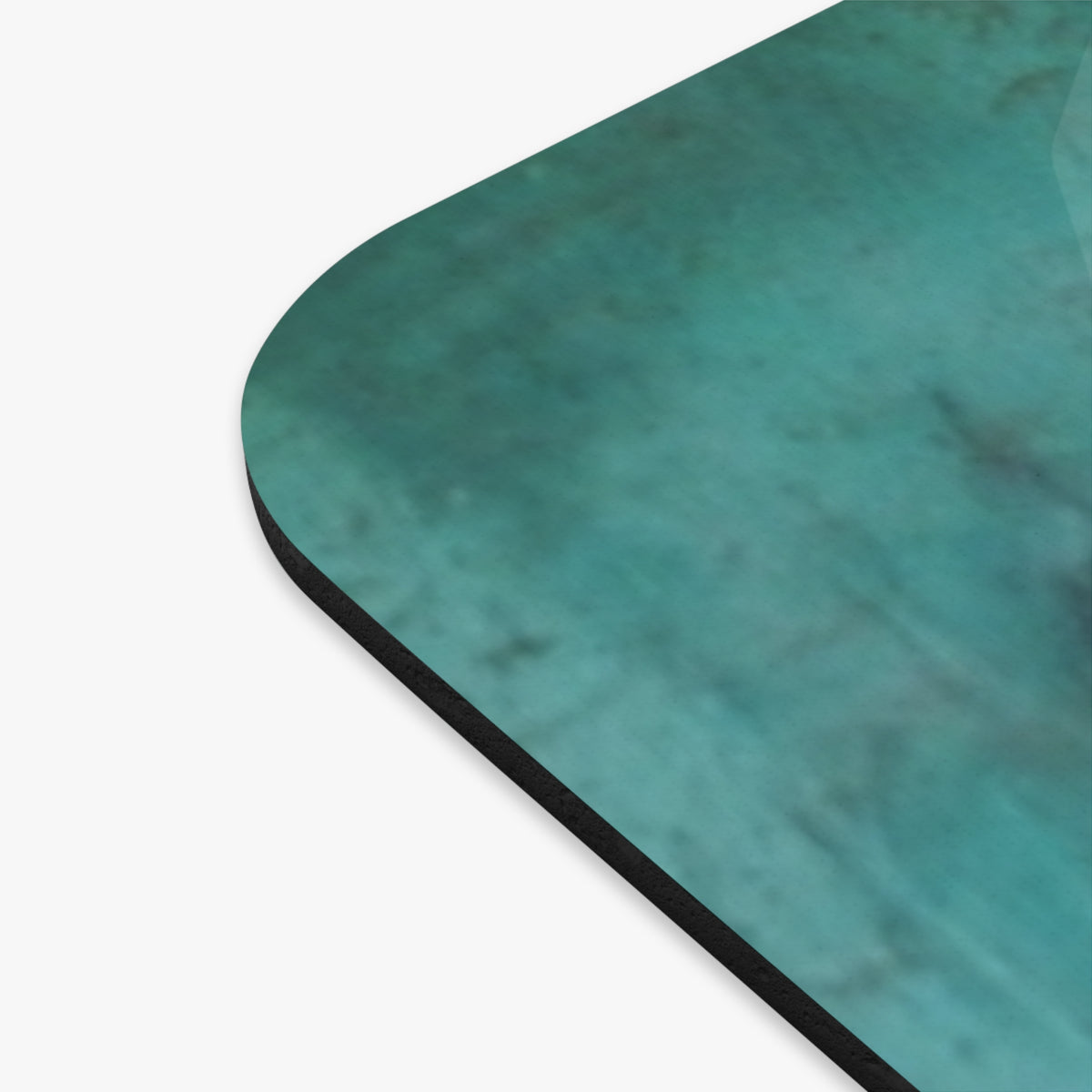a close up of the corner of the mouse pad showing the distressed greenish coloring.