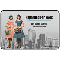 A grayscale city skyline serves as the background for two retro-styled women in 1950s dresses, one in teal and one in coral. Each holds an oversized vintage electronic device. The phrase “Reporting For Work” appears in bold black text, with a subheading that reads: “Love Triangle Analysts and Full-Time Flirts.” This is the small version.
