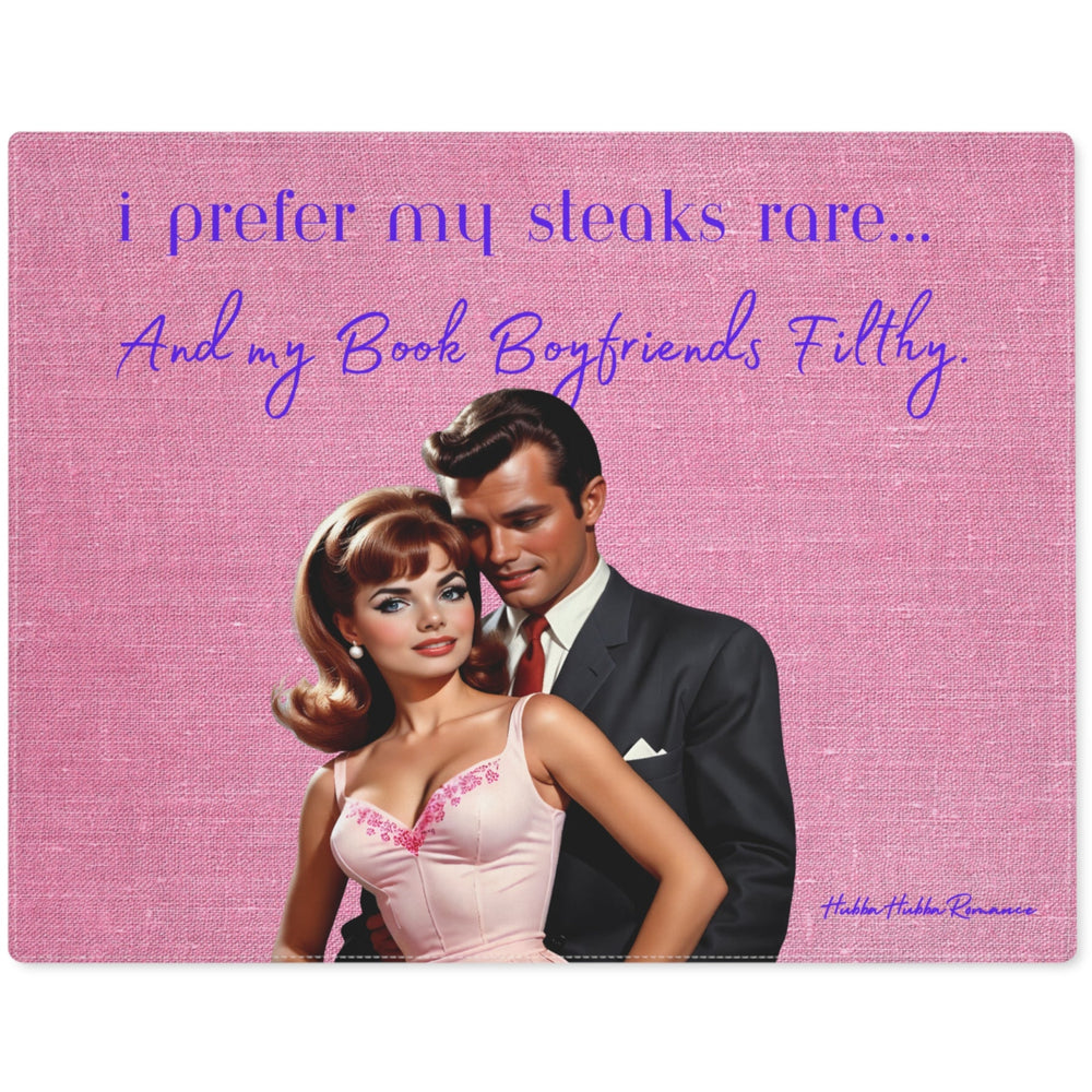 The image depicts a stylized vintage illustration of a glamorous couple. The woman, with voluminous brunette hair and a white evening gown, leans affectionately against a man in a sleek black suit. The background is a textured pink fabric, enhancing the retro aesthetic. Above them, playful text in cursive reads, "i prefer my steaks rare... and my Book Boyfriends Filthy." The design blends romance and humor, appealing to those who enjoy a touch of playful naughtiness in their literary tastes.
