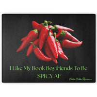 Glass cutting board with a black background featuring a pile of bright red chili peppers at the center. Below the image, lime green text reads: “I Like My Book Boyfriends To Be SPICY AF.” Made from durable, textured tempered glass with non-slip rubber feet, perfect for meal prep or as a bold kitchen accent. This is the larger size.