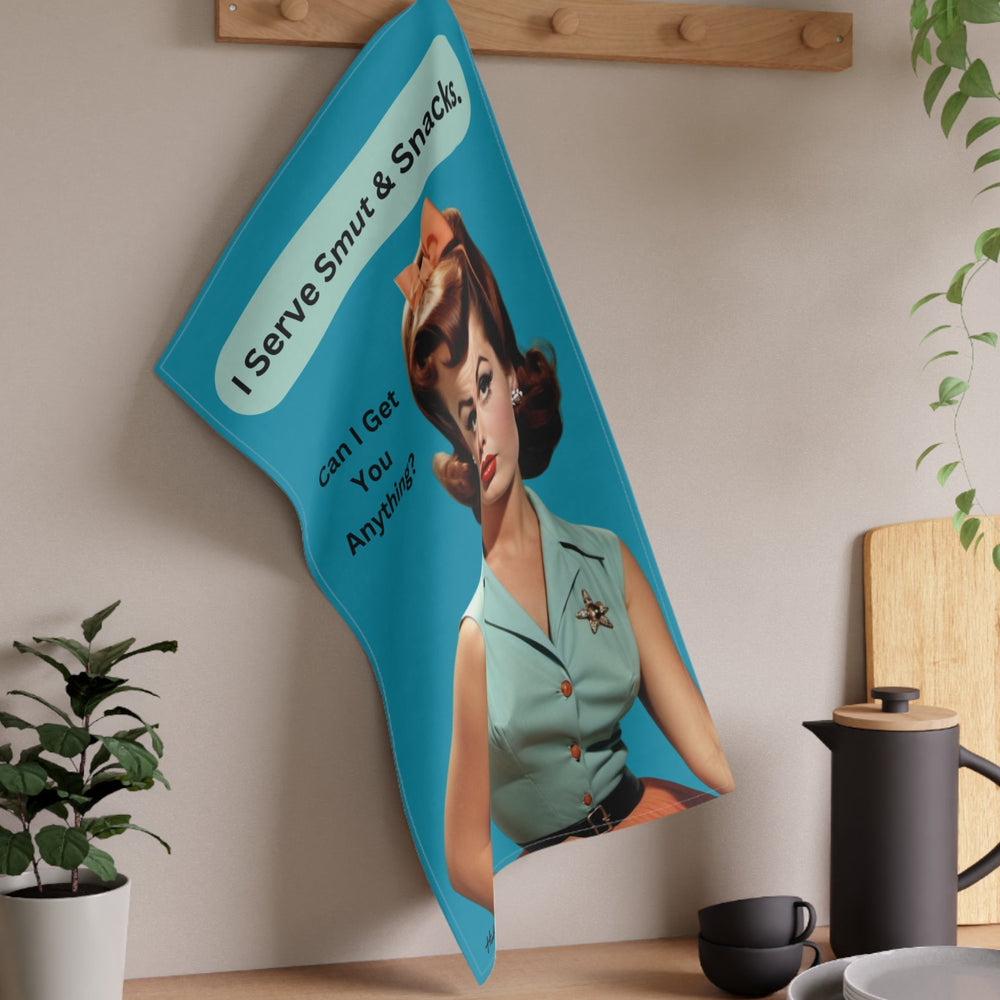 The towel is displayed on a wall hook in a kitchen setting.

