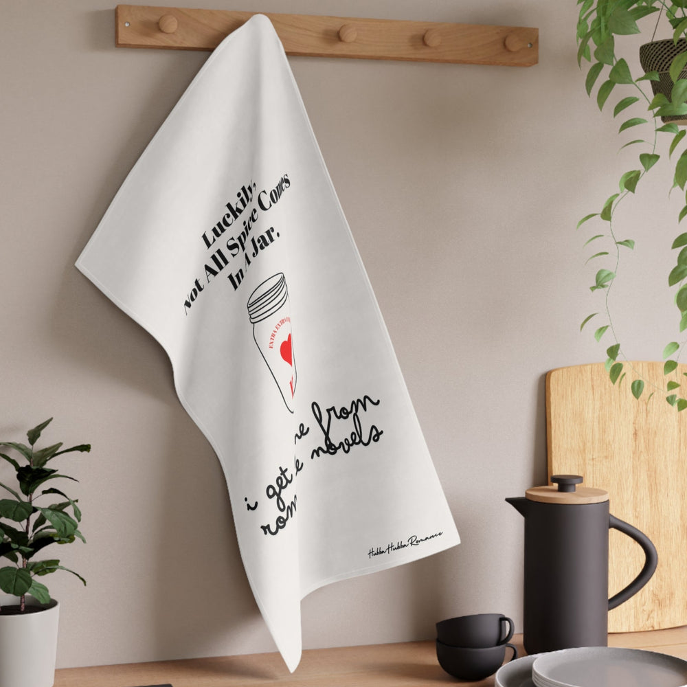 The towel is displayed on a wall hook in a kitchen setting.