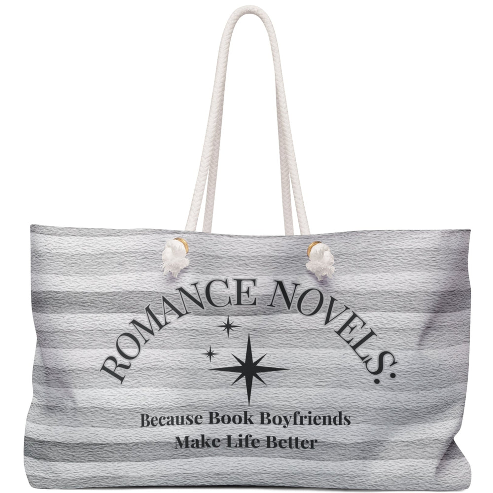 Image features a soft, gray-toned, horizontal striped background resembling textured fabric. Centered at the top in large, curved black serif text is the phrase “ROMANCE NOVELS:” followed by three black starburst icons of varying sizes underneath. Beneath the stars is the phrase “Because Book Boyfriends Make Life Better” in smaller, centered black serif text. The design is clean, elegant, and subtly whimsical—meant to evoke comfort, fantasy, and a love for fictional romance on a weekender bag.