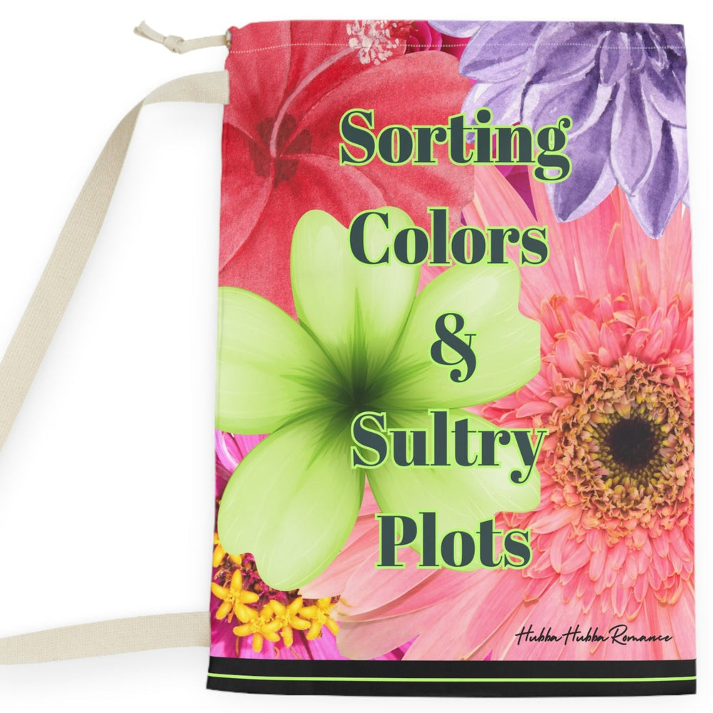This laundry bag features a vivid collage of oversized watercolor-style flowers, including pink zinnias, orange gerberas, red hibiscus, a purple dahlia, and a bright green orchid. Centered over the floral background is bold black text with a lime green shadow that reads: “Sorting Colors &Spicy Plots”. At the bottom of the bag is a black bar with a thin lime green line in the middle. The bag includes a drawstring closure and sturdy canvas carrying strap. This is the large bag.