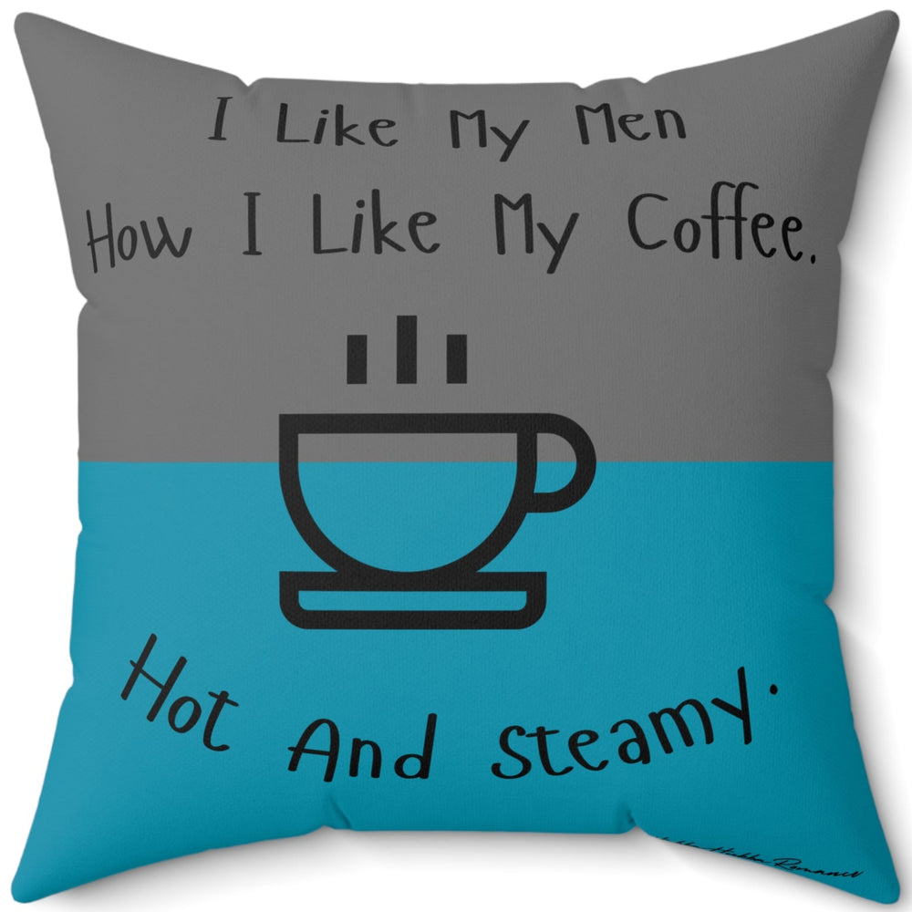 This image is of the backside of the pilow where the teal and gray colors are reversed. The 20 inch pillow features a split background with the top half in teal and the bottom half in gray. Centered at the top, black handwritten-style text reads: "I like my men how I like my coffee." Below, there is a simple black line drawing of a steaming coffee cup. Beneath the cup, curved text in black reads: "Hot and steamy." 
