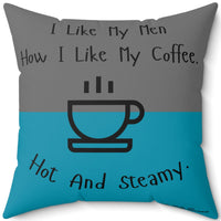 This image is of the backside of the pilow where the teal and gray colors are reversed. The 20 inch pillow features a split background with the top half in teal and the bottom half in gray. Centered at the top, black handwritten-style text reads: "I like my men how I like my coffee." Below, there is a simple black line drawing of a steaming coffee cup. Beneath the cup, curved text in black reads: "Hot and steamy." 