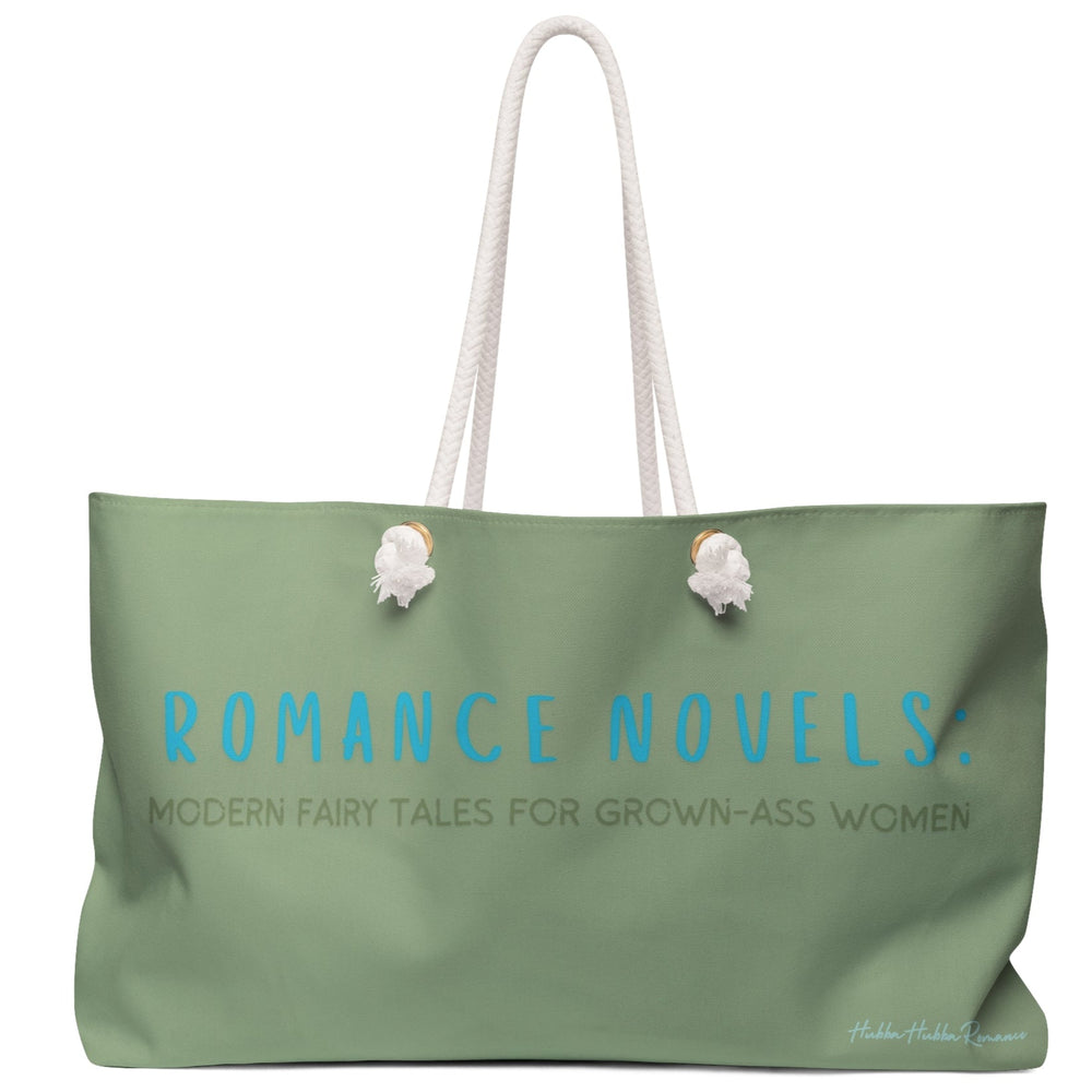 Image features a solid sage green background with bold, curved text in bright teal blue that reads “Romance Novels:”. Below it, in olive-toned all-caps font, it says “Modern Fairy Tales for Grown-Ass Women.” The aesthetic is modern and clean, with a cheeky twist that reclaims classic romance for a confident, adult audience. Printed on a weekender bag, the design appeals to women who love their stories spicy, their endings happy, and their bags ready for drama.