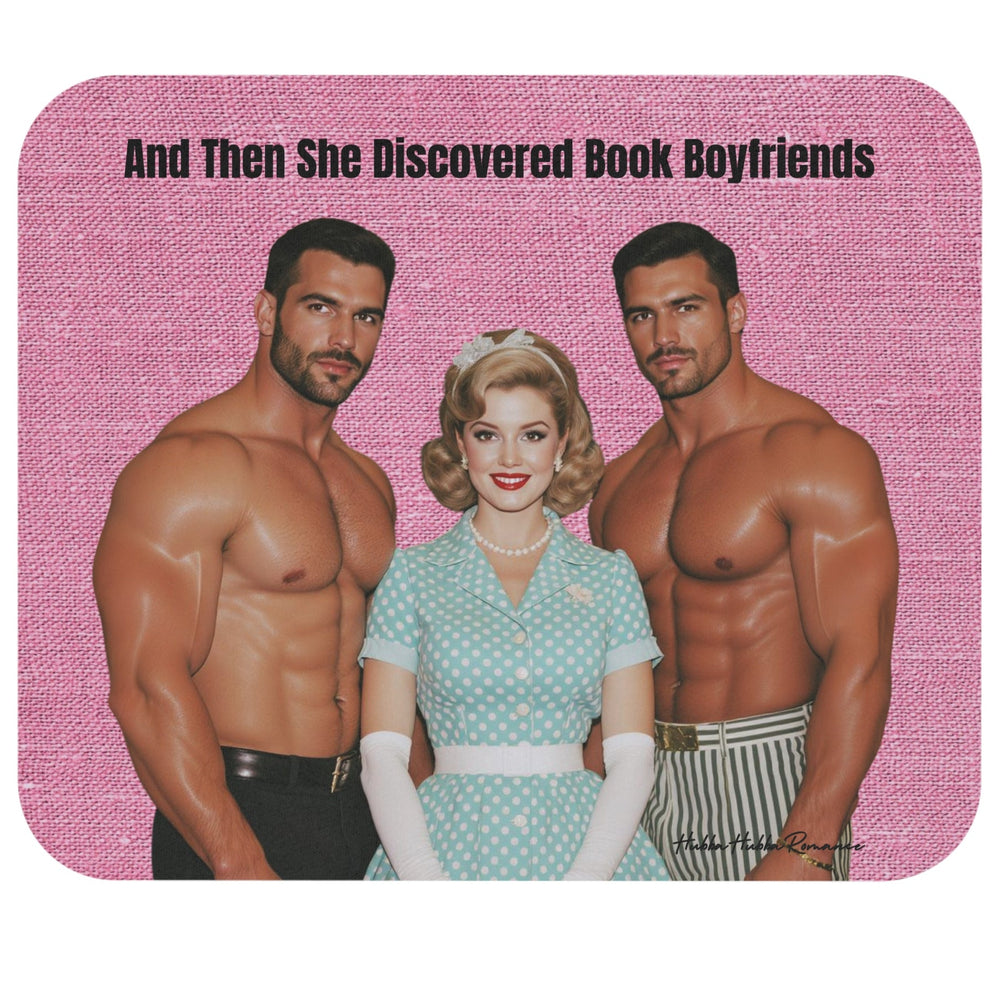 A square mouse pad with rounded corners featuring a pink textured background and the text 'And Then She Discovered Book Boyfriends' at the top. Below the text is a retro-style illustration of a blonde woman in a light blue polka-dot dress, flanked by two muscular shirtless men.