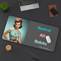 The desk mat is displayed with a laptop nearby and a mouse on it, with assorted office items lying on the desk as well.