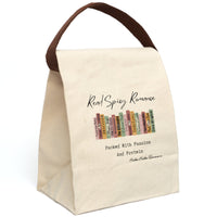 This canvas lunch bag features an illustrated row of romance book spines in muted earth tones, each labeled with tropes or titles like “Surprise Baby,” “Obsession,” “His Secret Fiancé,” “Twin Love,” and “Next Door Love.” Above the books, flowing script reads “Read Spicy Romance.” Below, in bold typewriter-style font, it says: “Packed With Passion And Protein.” The design blends a cheeky tone with a love for books. Bag includes canvas carrying strap, displayed upright, and roll-top closure.