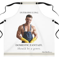 A white kitchen apron with black neck and waist ties, featuring a printed graphic of a shirtless muscular man in blue overalls and yellow gloves with the text 'INTRODUCING DOMESTIC FANTASY. Should be a genre.