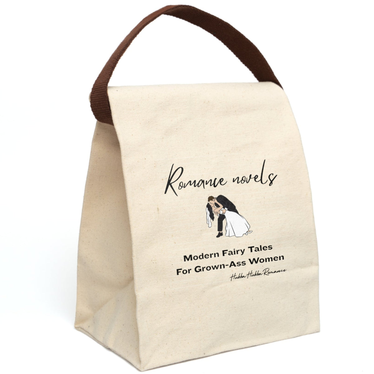 This canvas lunch bag features a plain canvas background with black text. At the top, the words “Romance novels” are written in an elegant script font. Below is an illustration of a bride and groom in a classic dip-kiss pose—the groom in a black suit, the bride in a flowing white gown and veil. Under the image, large bold text reads: “Modern Fairy Tales For Grown-Ass Women.” The design is romantic with a cheeky edge. The bag's canvas strap is displayed upright.