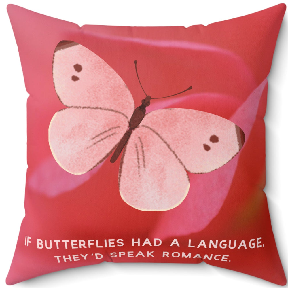 A 20-inch pillow featuring a soft pink butterfly with delicate brown markings on its wings, set against a blurred close-up of a pink flower petal. The butterfly has a watercolor-like texture and a graceful appearance. Below the butterfly, pale pink uppercase text reads: "If butterflies had a language, they’d speak romance." The background is a warm, romantic shade of pink, creating a dreamy and whimsical aesthetic.