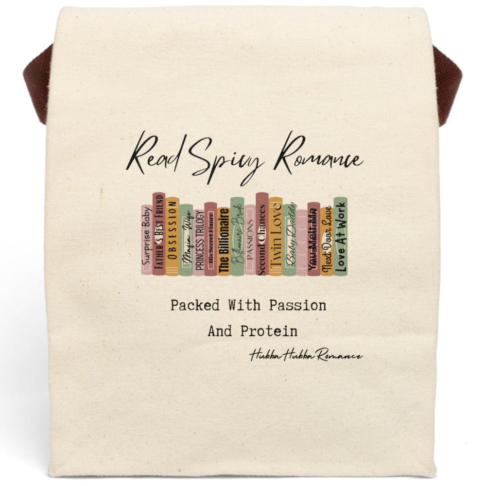 This canvas lunch bag features an illustrated row of romance book spines in muted earth tones, each labeled with tropes or titles like “Surprise Baby,” “Obsession,” “His Secret Fiancé,” “Twin Love,” and “Next Door Love.” Above the books, flowing script reads “Read Spicy Romance.” Below, in bold typewriter-style font, it says: “Packed With Passion And Protein.” The design blends a cheeky tone with a love for books. Bag includes canvas carrying strap and roll-top closure.