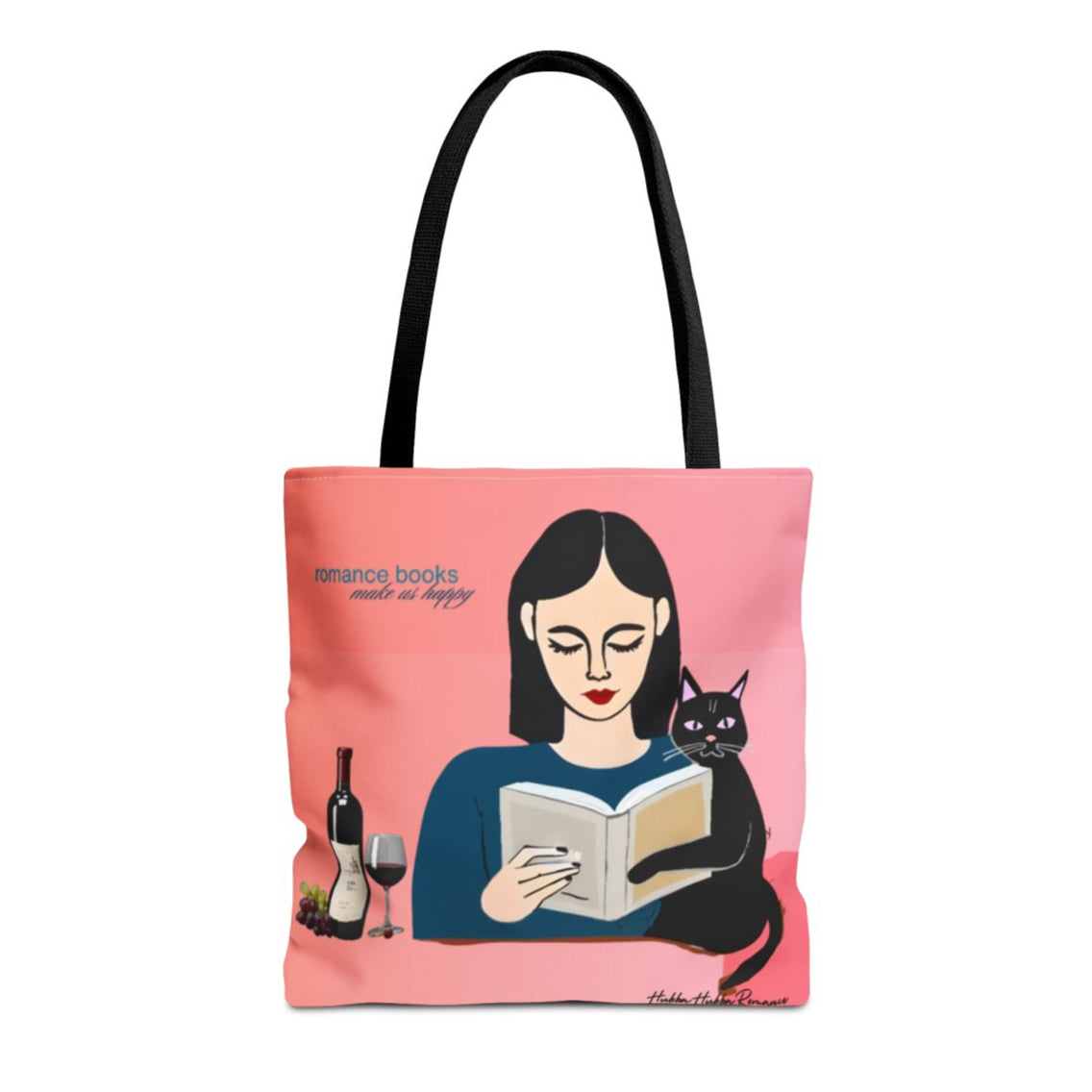 Tote bag with pink-to-coral gradient background, illustrated woman with long black hair reading, black cat resting on book, and text: “Romance Books Make Us Happy.” Wine bottle, glass, and grapes beside her.