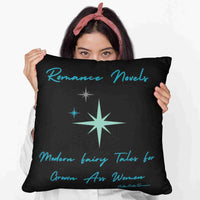 A woman holding up a 20-inch pillow featuring a bold black background with elegant teal script at the top reading: "Romance Novels." Below, in a playful, modern font, the phrase "modern fairy tales for grown-ass women" is displayed. To the left of the text, there are three teal starbursts in varying sizes, adding a vintage-inspired, whimsical touch. The minimalist yet striking design conveys a love for romance books with a sassy, empowering attitude.

