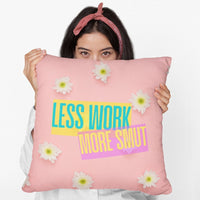 A woman holds a 20-inch pillow featuring a pastel pink background scattered with fresh white daisies. Bold, colorful text overlays the center, reading "LESS WORK" in bright teal on a yellow background and "MORE SMUT" in hot pink on a purple background. The playful, modern typography and vibrant color contrast give the design a fun, sassy, and energetic vibe, perfect for romance readers who prioritize their book boyfriends over their to-do lists.