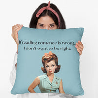 A woman holding a 20-inch pillow featuring a vintage-inspired illustration of a glamorous 1950s woman with red hair styled in curls, wearing a mint green blouse with orange buttons, an orange skirt, a black belt, and a matching orange bow in her hair. She has bold red lipstick and a skeptical expression. The background is a solid teal color. Above her, black text reads: "If reading romance is wrong, I don’t want to be right."