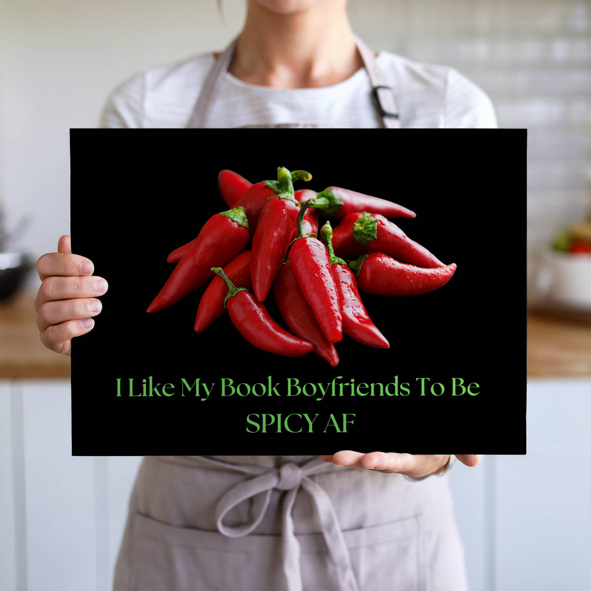 The cutting board is displayed upright in the hands of a cook to convey its size. This is the larger version.