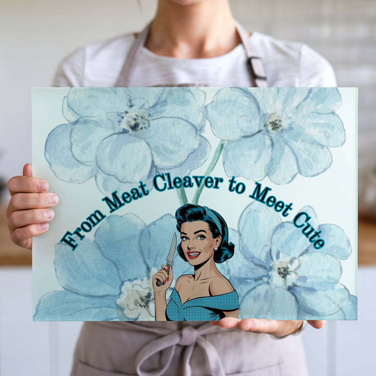 The cutting board is displayed upright in the hands of a cook to convey its size. This is the larger version.
