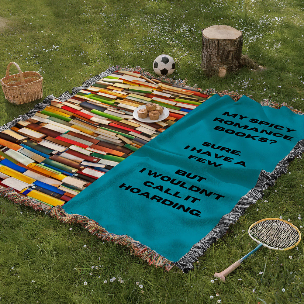 The blanket is being displayed as a picnic blanket in a park setting with a tree stump, picnic basket, plate of muffins, and a tennis racquet and a soccer ball lying around.

