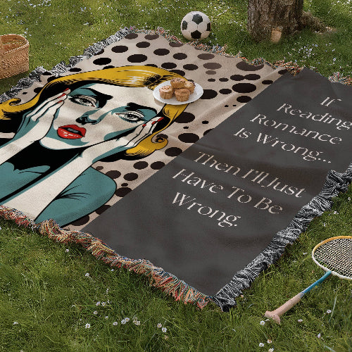 Woven blanket with pop-art crying heroine on dotted backdrop and text: “If reading romance is wrong, then I’ll have to be wrong.” displayed as a picnic blanket in a park setting. 

