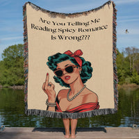 This woven blanket features a vintage-inspired woman in red with a pearl necklace, a red hair scarf, and a low-cut red top with red sunglasses and a bold attitude, paired with the text: “Are You Telling Me Reading Spicy Romance Is Wrong???” She is holding up her middle finger in a defiant gesture. A perfect statement piece for romance readers who love humor, heat, and unapologetic style. 