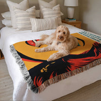 Large woven cotton fringe blanket featuring colorful pop art artwork and romance reader quote displayed on a bed with a dog lounging on top, cozy book lover home décor.