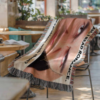 Funny romance reader woven blanket draped over a chair featuring an intense staring face and bold reading quote.