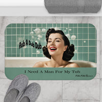 The bath mat is displayed next to a tub with a pair of slippers for size context.
