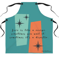 A teal apron with black straps features a retro mid-century modern design with abstract teal and orange shapes, accented by black starbursts. The text across the apron reads: "Love is like a recipe. Sometimes you nail it, sometimes it’s a disaster."