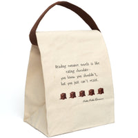 This canvas lunch bag features a plain background with playful black text that reads: “Reading romance novels is like eating chocolate—you know you shouldn’t, but you just can’t resist.” Below the quote is a row of five illustrated melting chocolate truffles, evenly spaced. The font is whimsical, and the overall design is light-hearted and sweet. The bag includes a sturdy canvas body with a roll-top closure and carry strap which is displayed upright.