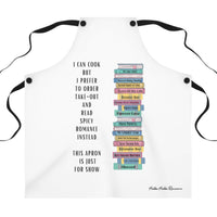 A white apron features a vertical stack of illustrated romance novels with colorful spines. To the left of the books, black text reads: "I can cook, but I prefer to order take-out and read spicy romance instead. This apron is just for show."

