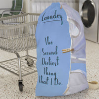 This laundry bag features two white tank tops pinned to a clothesline against a bright blue sky. To the left side of the t-shirts is a playful message in elegant black text: “Laundry. The second dirtiest thing that I do.” The visual combines clean imagery with cheeky humor, making it a fun and functional bag for readers who love steamy romance and tidy piles. The bag has a drawstring closure and a large canvas strap for carrying. This is the large version. It is displayed in front of a cart for size context