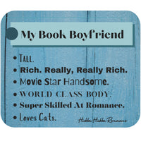 This mouse pad has a blue wood background with text that Says "My Book Boyfriend and then lists six traits: Tall, Really Really Rich, Movie Star Handsome, World Class Body, Super Skilled At Romance,  Loves Cats