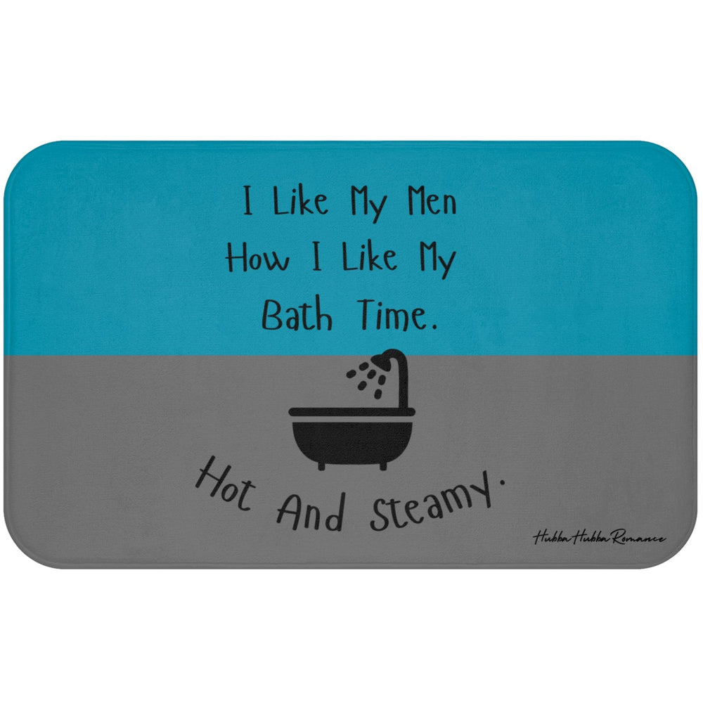 This bath mat features two background colors: teal on the top half and gray on the bottom half. The top half includes playful black text that reads: “I Like My Men How I Like My Bath Time.” Centered in the lower half is a black graphic of a vintage-style bathtub with a shower head spraying water. Below the tub, curved black text reads: “Hot And Steamy.” The mat is soft, absorbent, and designed for romance readers with a cheeky sense of humor.
This is the larger sized mat.